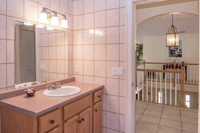 bathroom with vanity, tile patterned flooring, and tile walls