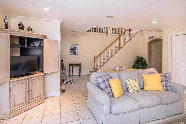 living room featuring light tile patterned floors, arched walkways, recessed lighting, stairs, and ornamental molding