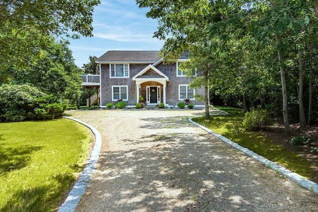 view of front of house with driveway and a front lawn