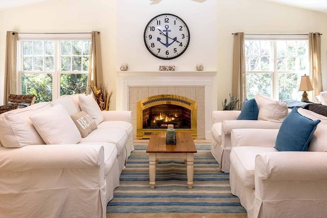 living room featuring vaulted ceiling and a tiled fireplace