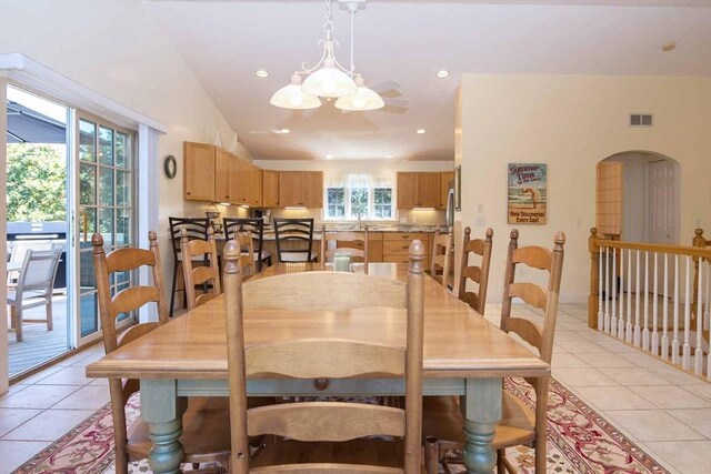 dining room featuring a healthy amount of sunlight, visible vents, and light tile patterned flooring