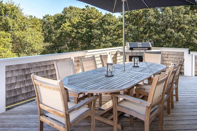 wooden deck with a grill and outdoor dining space