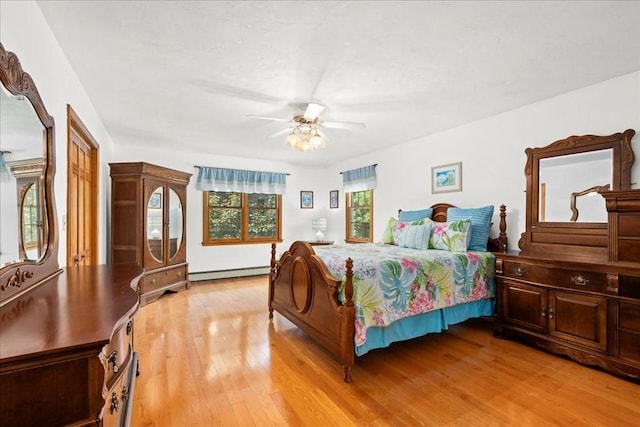 27 Crestview Dr, Uxbridge, MA 01569 - bedroom with a baseboard heating unit, light wood finished floors, and ceiling fan