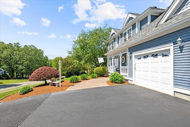 27 Crestview Dr, Uxbridge, MA 01569 - view of patio with asphalt driveway and a garage