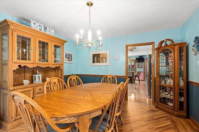 27 Crestview Dr, Uxbridge, MA 01569 - dining room featuring a chandelier, light wood finished floors, and a wainscoted wall