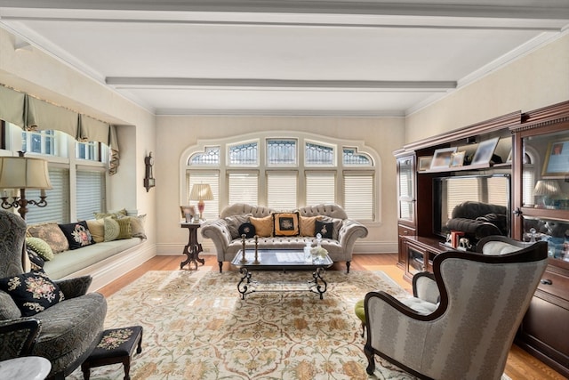 living room featuring crown molding, light hardwood / wood-style floors, and beamed ceiling