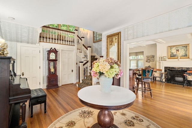 foyer entrance featuring wood-type flooring and a fireplace