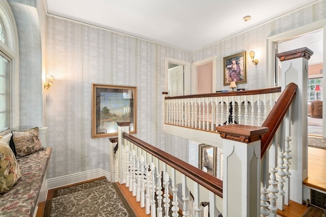 stairs featuring hardwood / wood-style flooring and crown molding