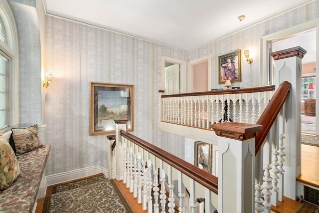 hall featuring radiator heating unit, hardwood / wood-style floors, and crown molding