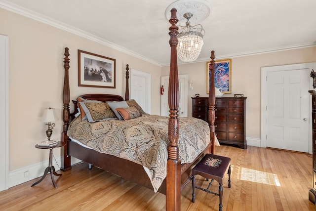 bedroom featuring light hardwood / wood-style flooring, a chandelier, and crown molding