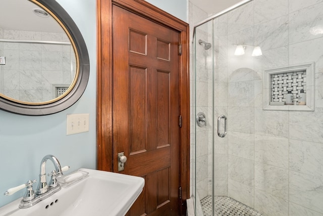 bathroom featuring an enclosed shower and sink