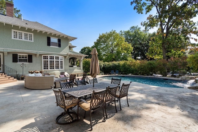 view of patio with a fenced in pool and outdoor lounge area