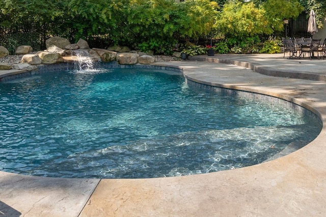 view of swimming pool featuring a patio area and pool water feature