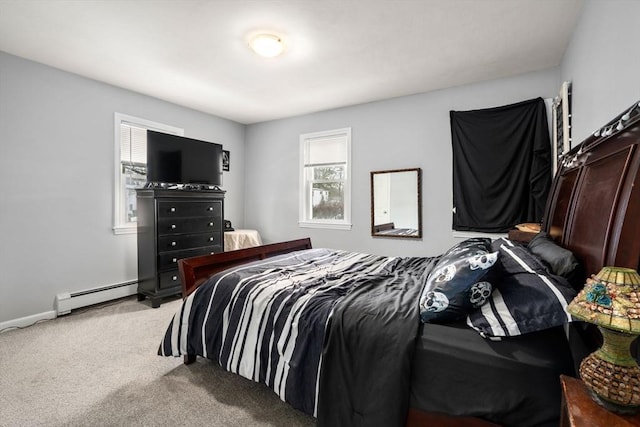 bedroom with a baseboard radiator, baseboards, and carpet flooring