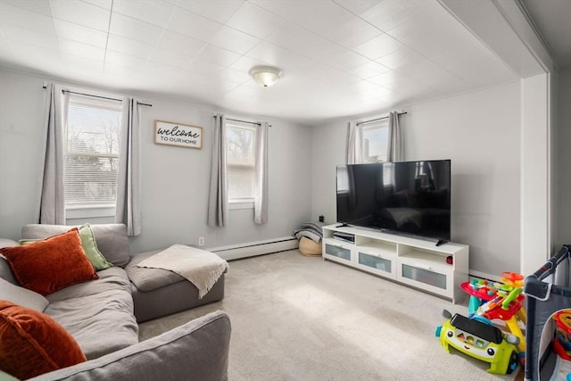 living room with a wealth of natural light, a baseboard radiator, and carpet flooring