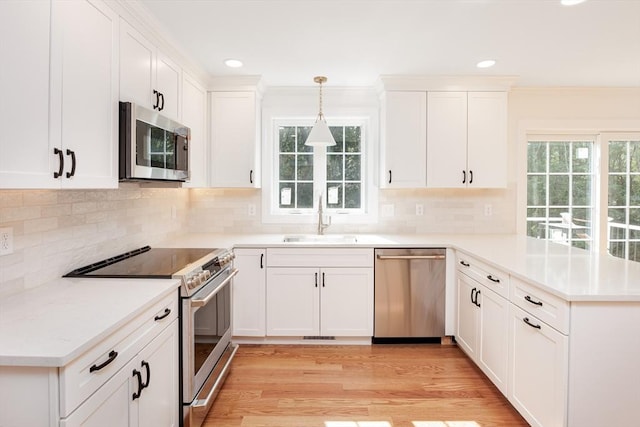 100 King St, Groveland, MA 01834 - kitchen with appliances with stainless steel finishes, a peninsula, healthy amount of natural light, recessed lighting, and white cabinetry
