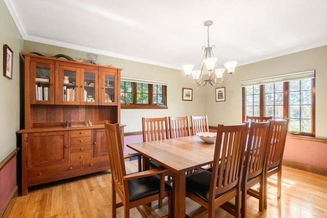 36 Blake Rd, Brookline, MA 02445 - dining space featuring light wood finished floors, crown molding, and a chandelier