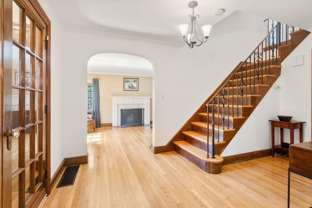 36 Blake Rd, Brookline, MA 02445 - interior space with wood finished floors, a fireplace, visible vents, stairway, and arched walkways