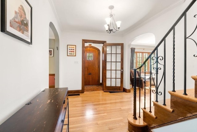 36 Blake Rd, Brookline, MA 02445 - foyer with arched walkways, ornamental molding, and light wood finished floors