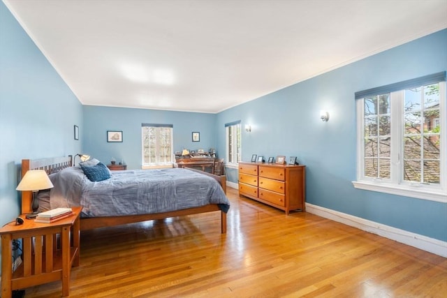 36 Blake Rd, Brookline, MA 02445 - bedroom with light wood finished floors, baseboards, and multiple windows