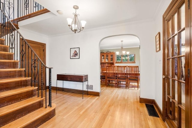 36 Blake Rd, Brookline, MA 02445 - foyer with baseboards, visible vents, stairway, arched walkways, and a notable chandelier