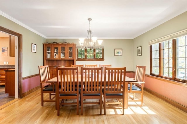 36 Blake Rd, Brookline, MA 02445 - dining area with baseboards, a notable chandelier, light wood-style flooring, and ornamental molding
