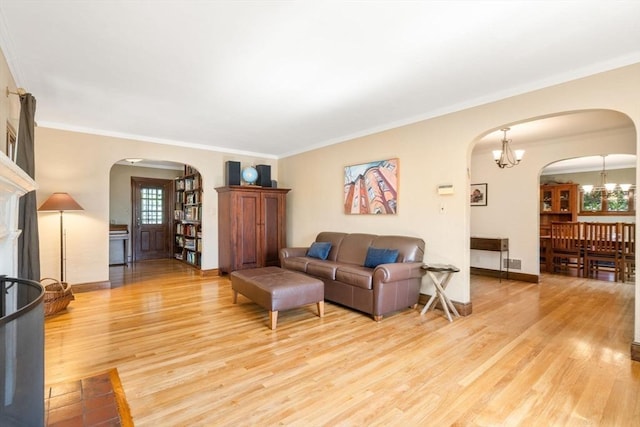 36 Blake Rd, Brookline, MA 02445 - living room featuring crown molding, light wood-style flooring, and arched walkways