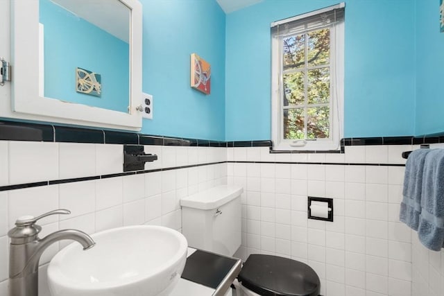 36 Blake Rd, Brookline, MA 02445 - half bath featuring toilet, tile walls, a wainscoted wall, and a sink