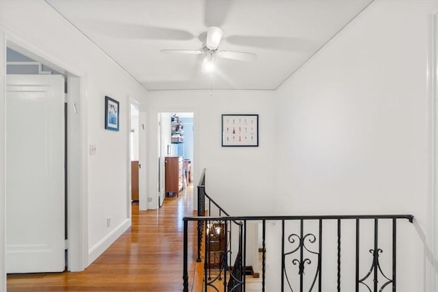 36 Blake Rd, Brookline, MA 02445 - hallway featuring wood finished floors, an upstairs landing, and baseboards