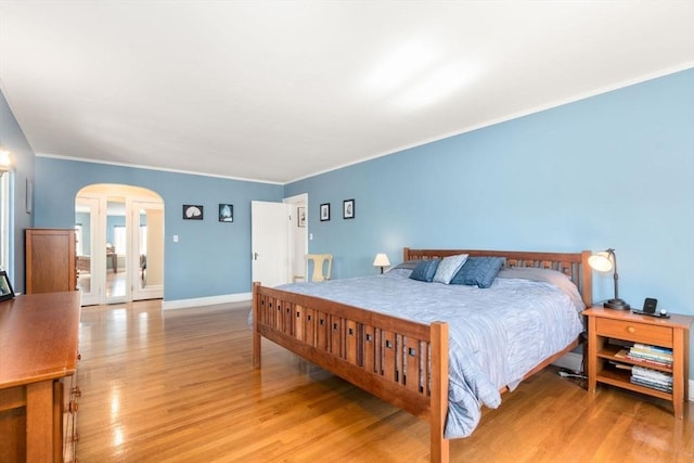 36 Blake Rd, Brookline, MA 02445 - bedroom with ornamental molding, light wood-type flooring, baseboards, and arched walkways