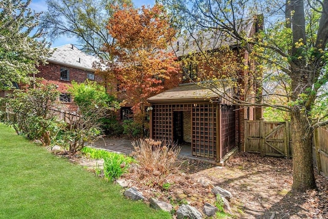 36 Blake Rd, Brookline, MA 02445 - view of yard featuring an outdoor structure, fence, and a gate