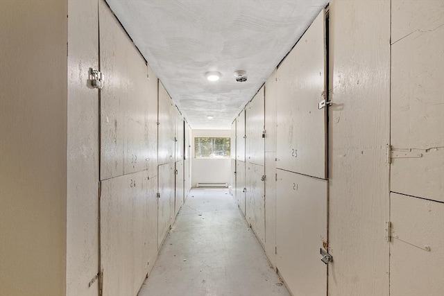 176 Maple Ave Unit 5-5, Rutland, MA 01543 - corridor with a baseboard heating unit and unfinished concrete flooring