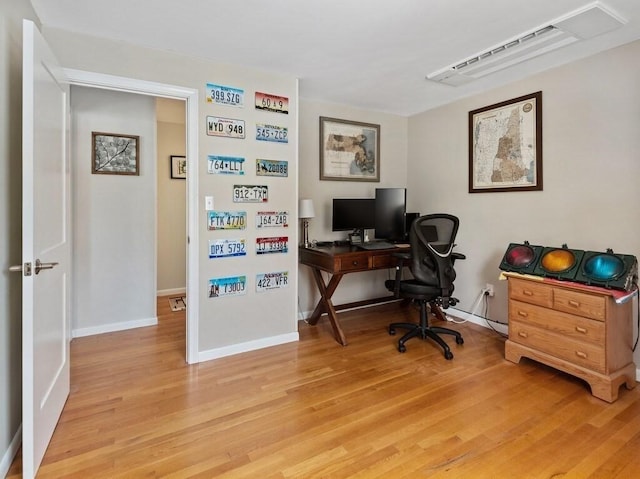 office area featuring light wood-style flooring and baseboards