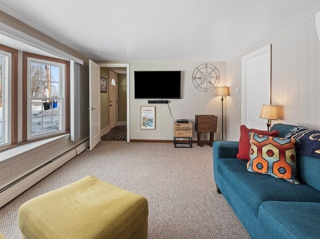 carpeted living area with a baseboard radiator and baseboards