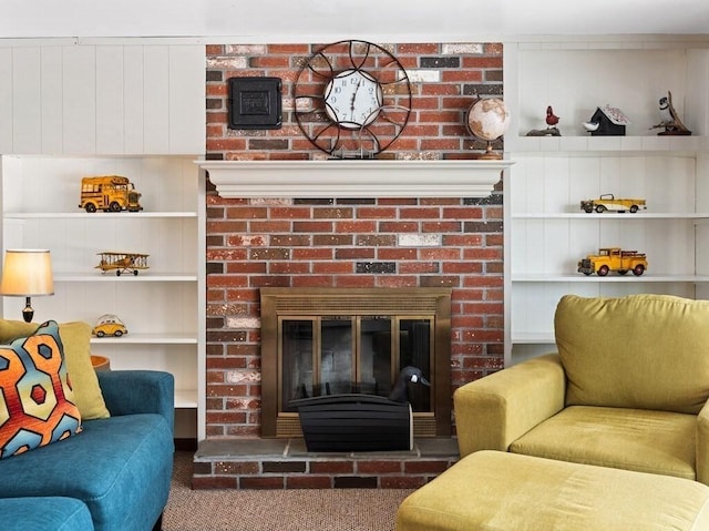 carpeted living area with built in features and a brick fireplace