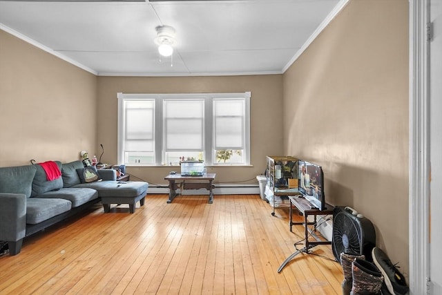 sitting room with light hardwood / wood-style floors, ornamental molding, and baseboard heating