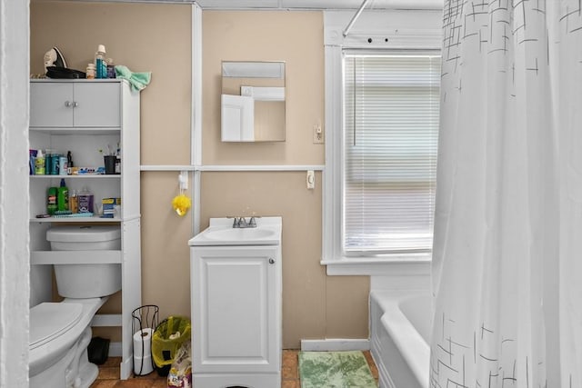 full bathroom featuring vanity, shower / bath combo, and toilet