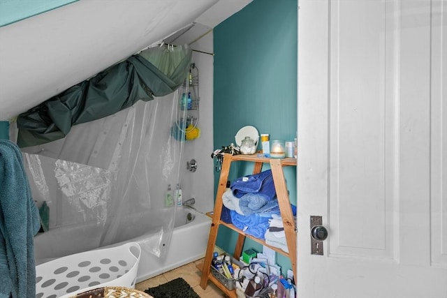 bathroom with tile patterned floors and shower / tub combo with curtain