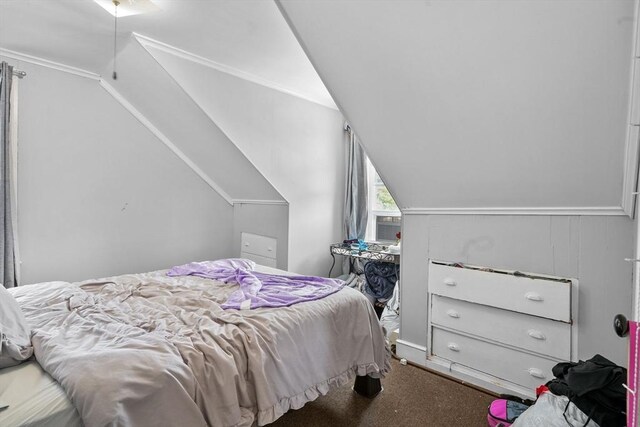 carpeted bedroom featuring cooling unit and vaulted ceiling