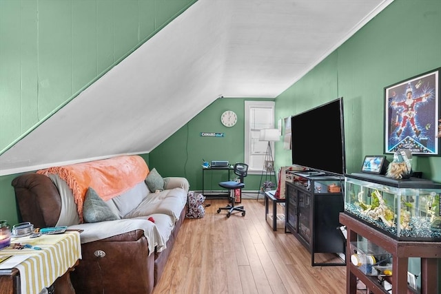 living room featuring baseboard heating, light hardwood / wood-style floors, and lofted ceiling