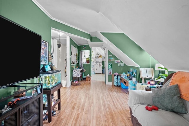 living room featuring hardwood / wood-style floors, vaulted ceiling, and ornamental molding