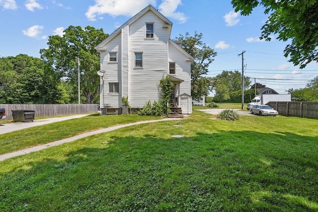 back of property featuring a lawn