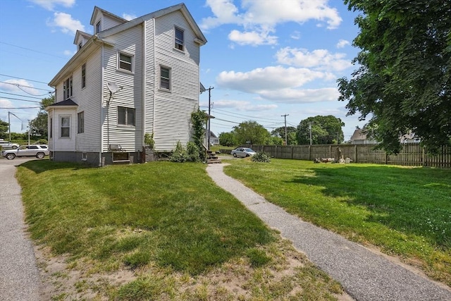 view of property exterior featuring a lawn