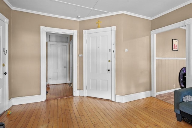 foyer entrance with wood-type flooring and ornamental molding