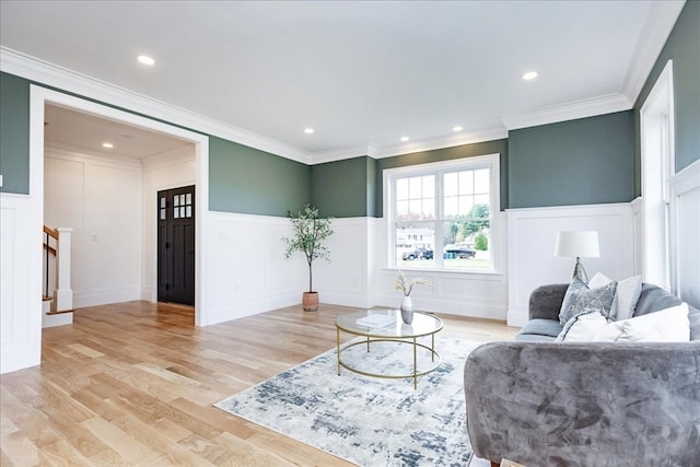 living room featuring light wood-type flooring and ornamental molding