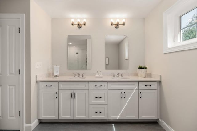 62 High St Lot 3, Stoneham, MA 02180 - bathroom with double vanity, a shower with shower door, and baseboards