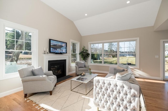 62 High St Lot 3, Stoneham, MA 02180 - living area with wood finished floors, plenty of natural light, a fireplace with flush hearth, baseboards, and recessed lighting