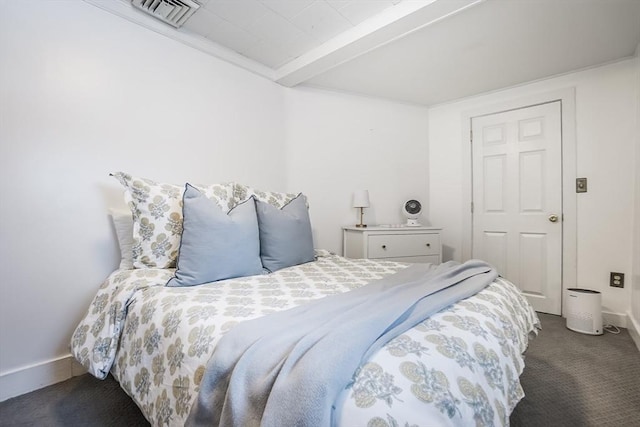 bedroom featuring beam ceiling, dark carpet, visible vents, and baseboards