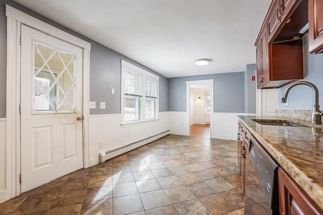 kitchen with dishwashing machine, a baseboard heating unit, a wainscoted wall, a sink, and light stone countertops