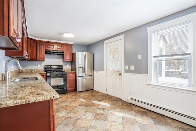 kitchen with a baseboard heating unit, black range with gas cooktop, a sink, stainless steel fridge, and under cabinet range hood